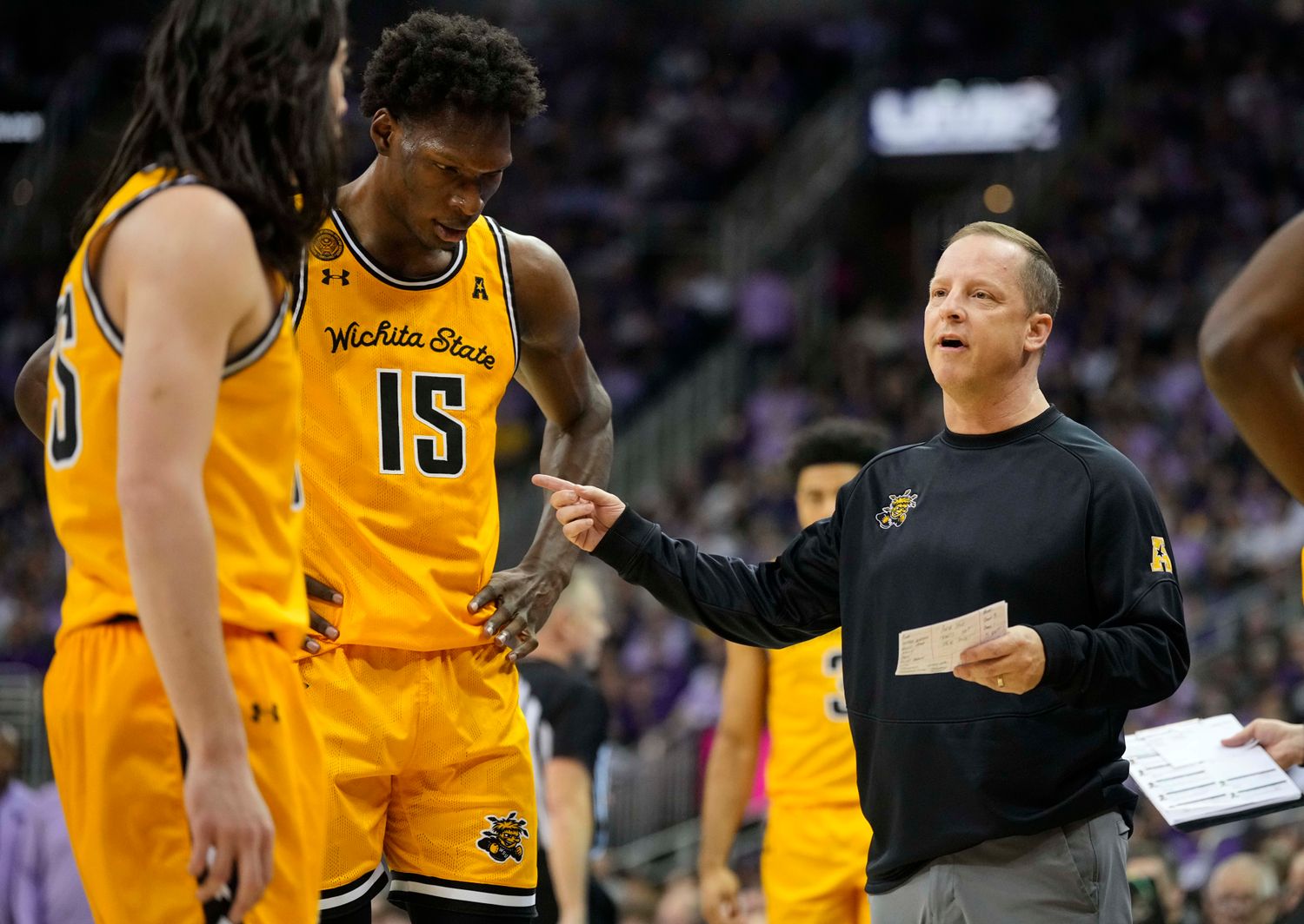 Dec 21, 2023; Kansas City, Missouri, USA; Wichita State Shockers head coach Paul Mills talks to his team during a timeout in the first half against the Kansas State Wildcats at T-Mobile Center.